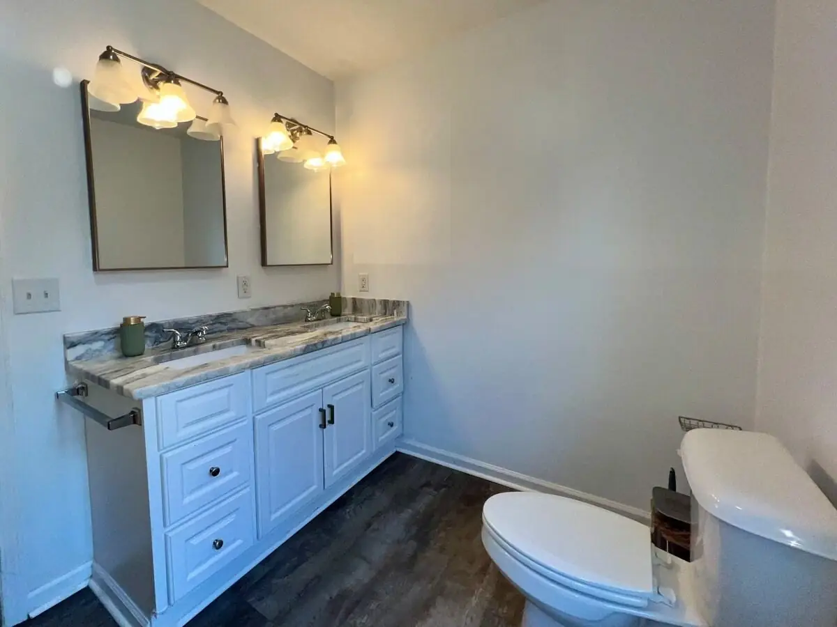 Bathroom vanity, mirrors and toilet wiped down and polished during a short-term rental turnover in Carrollton, GA