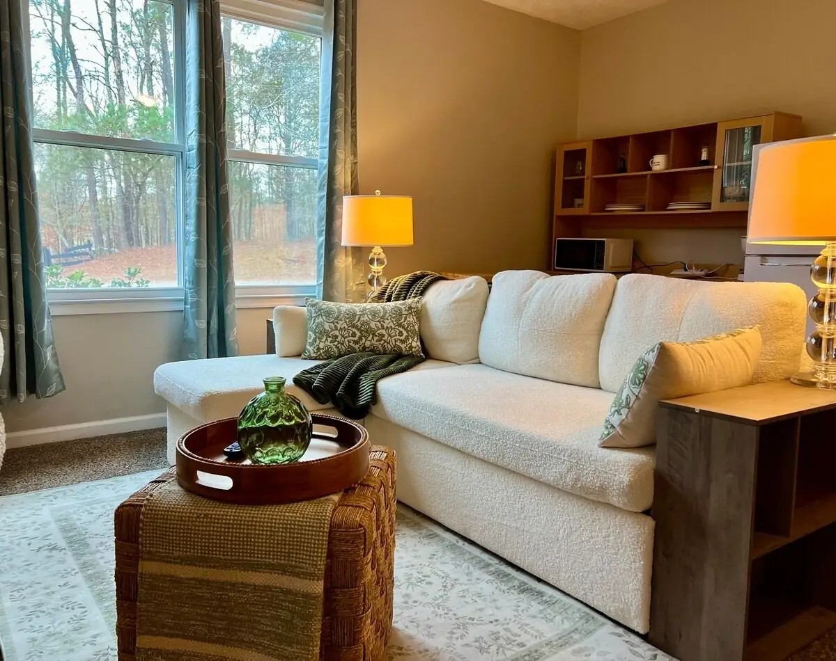 Sofa, lamps and side tables reset in a clean rental living room with natural light in Carrollton, GA