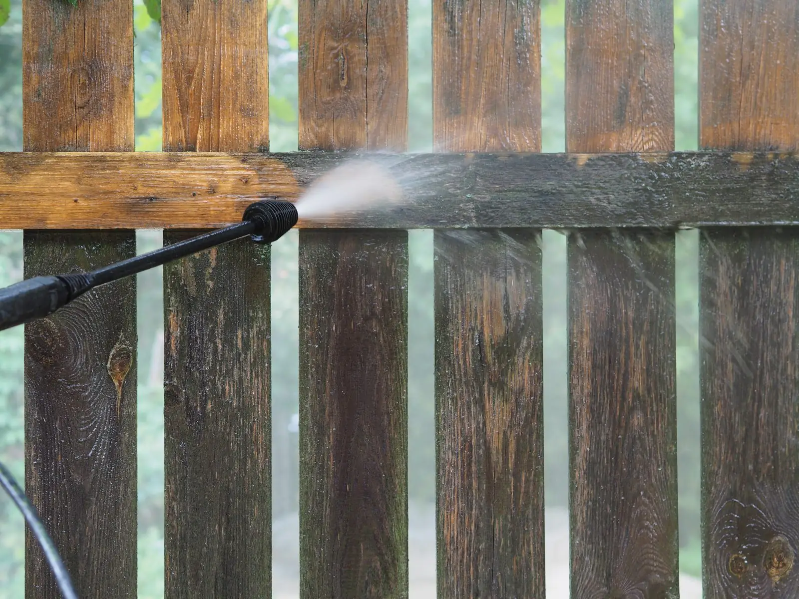 Wood fence being pressure washed in Carrollton, GA