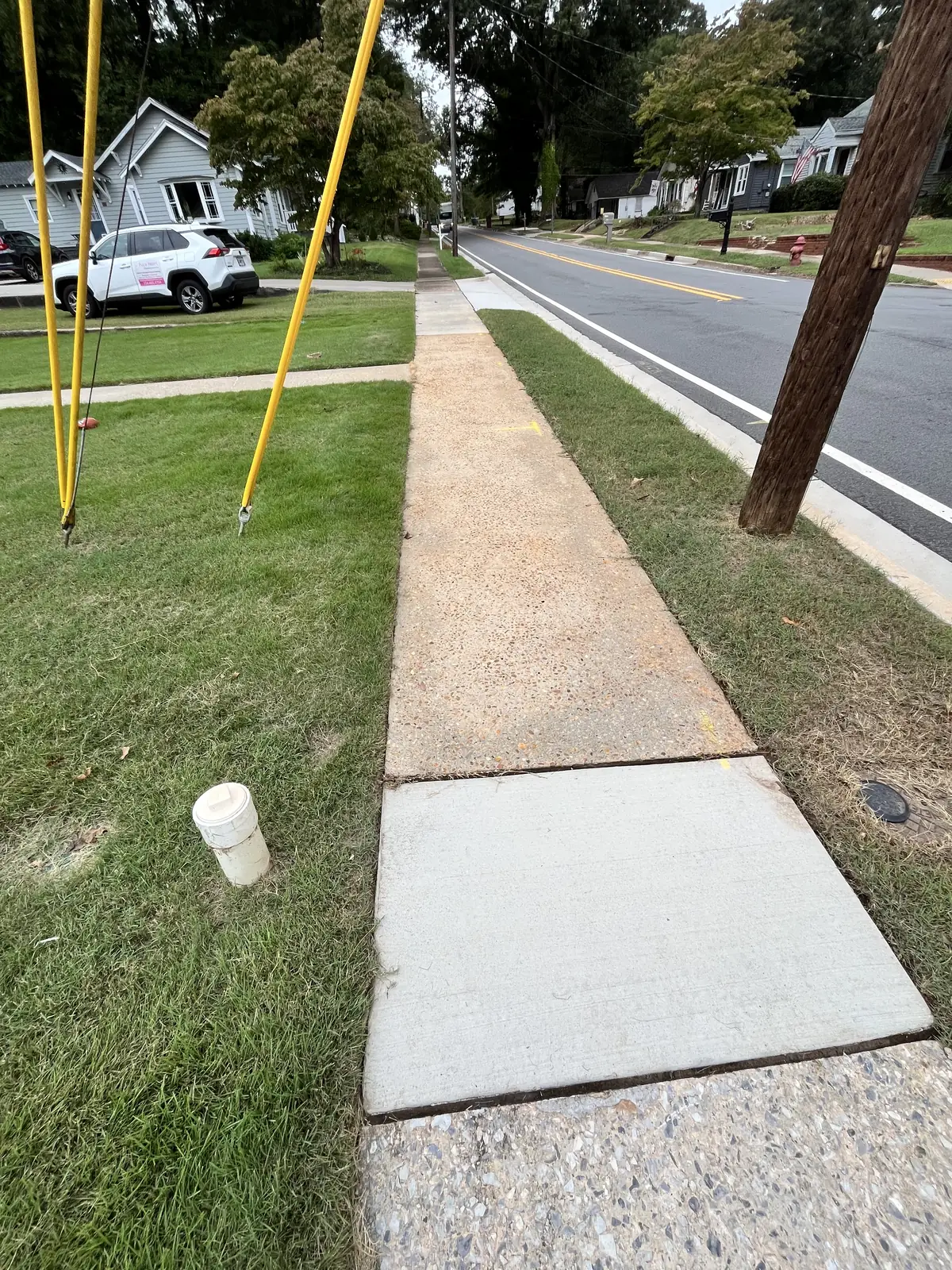 Same street-side sidewalk after pressure washing in Carrollton, GA
