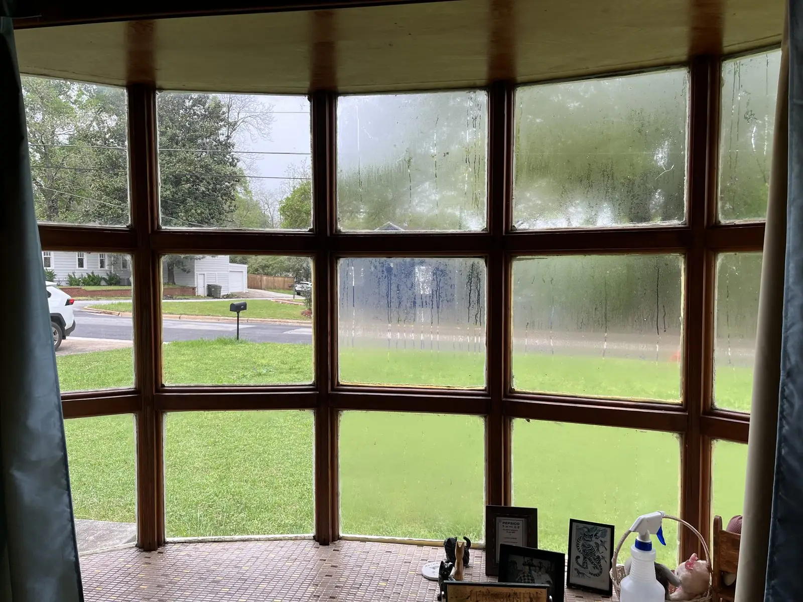 Bay window panes covered in water spotting and film before cleaning in Carrollton, GA